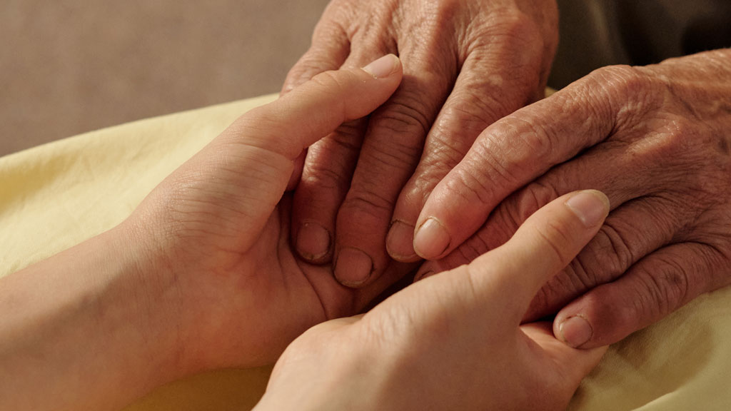 Close-up of intertwined hands showing connection during emotional regulation